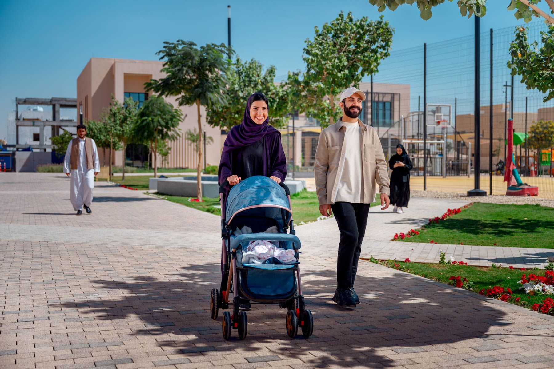 Family walking through a ROSHN Group community