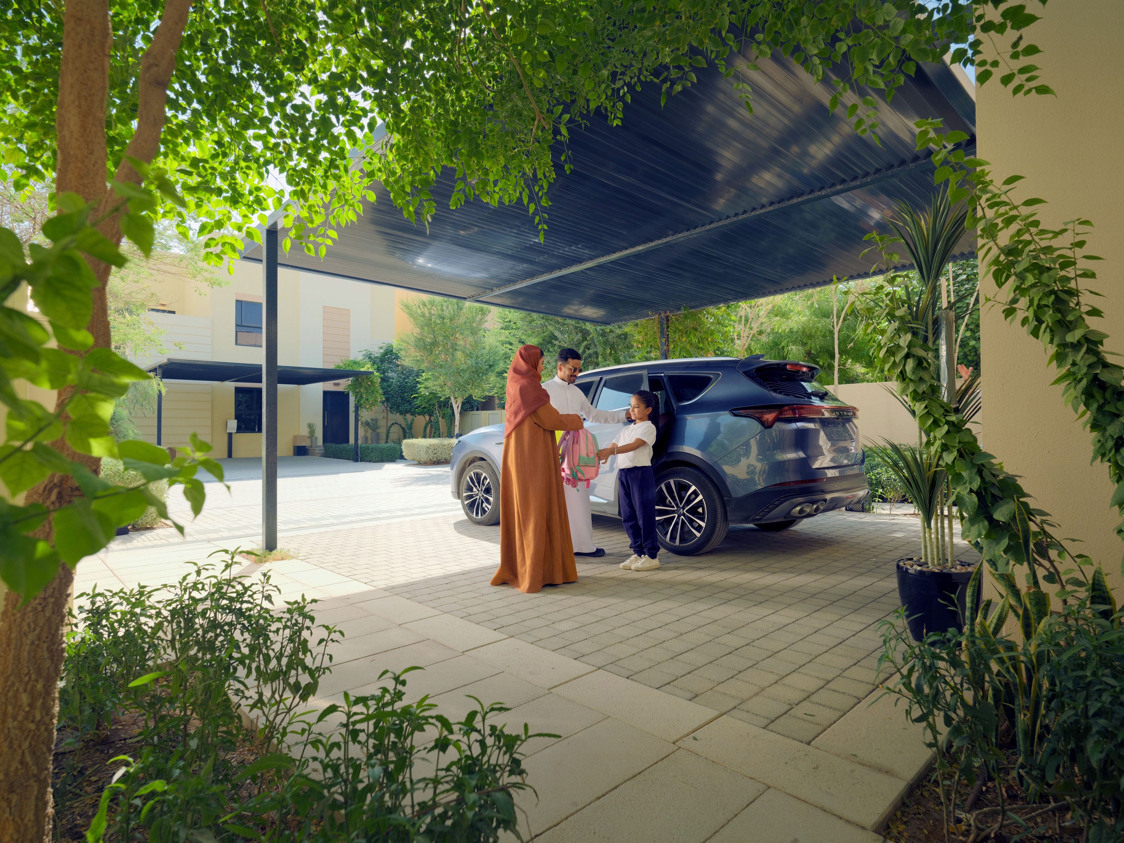 Family enjoying life in a ROSHN Group community, showcasing vibrant neighborhood living